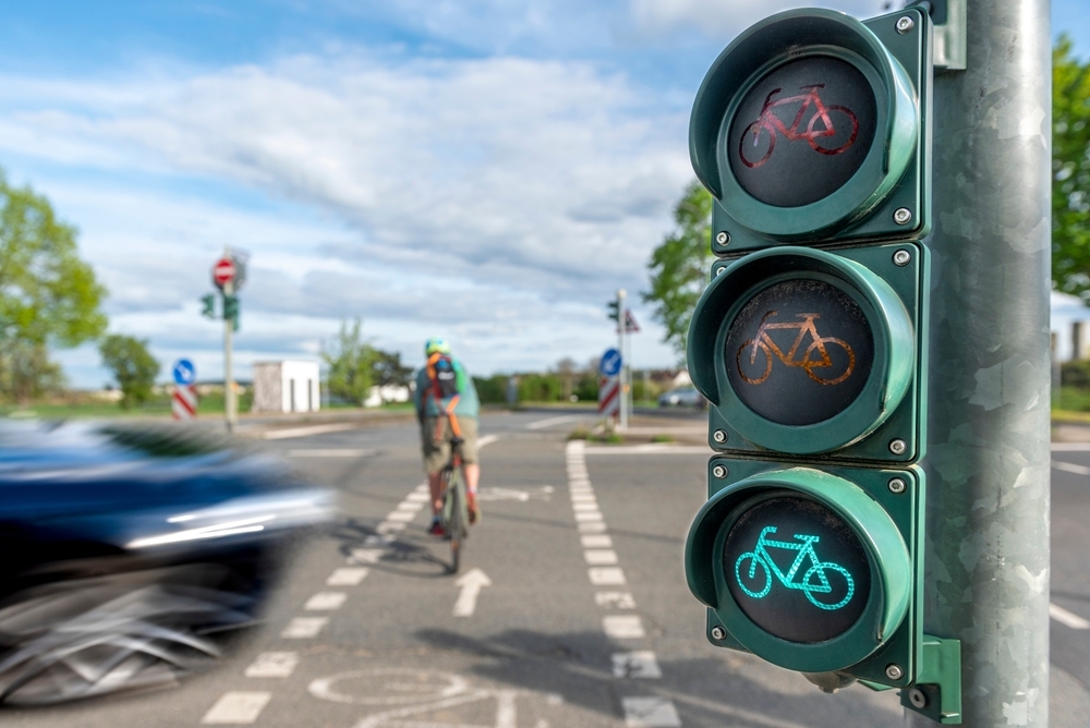 Cyclist riding through intersection with bicycle traffic light in Atlanta