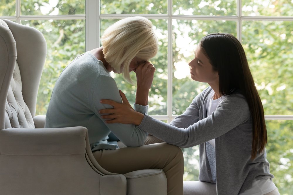 Woman comforting grieving family member after wrongful death in Georgia