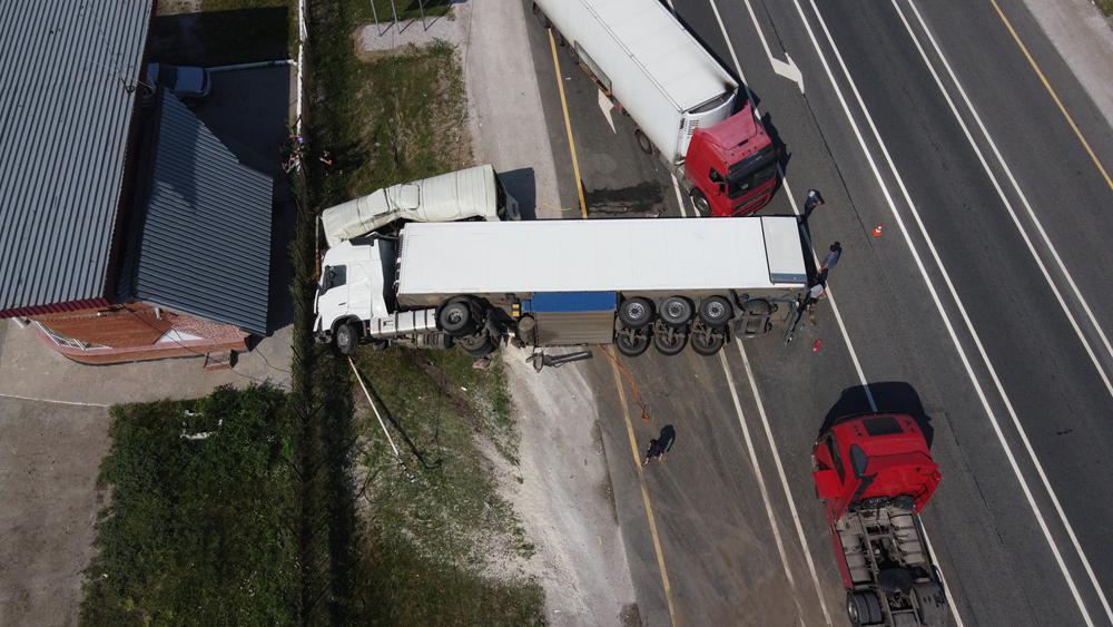 Aerial view of a truck accident where a trailer ran off the road near a warehouse