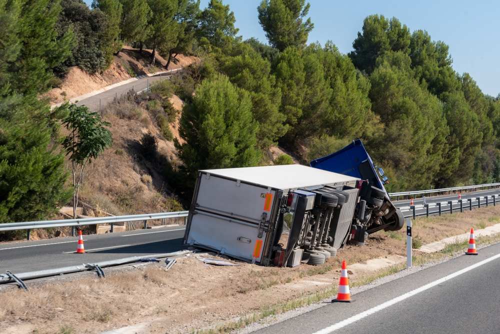 Overturned truck on highway shoulder after a Georgia truck accident