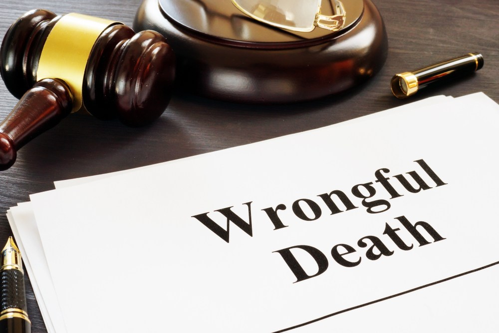 Document titled "Wrongful Death" next to a judge's gavel and pen