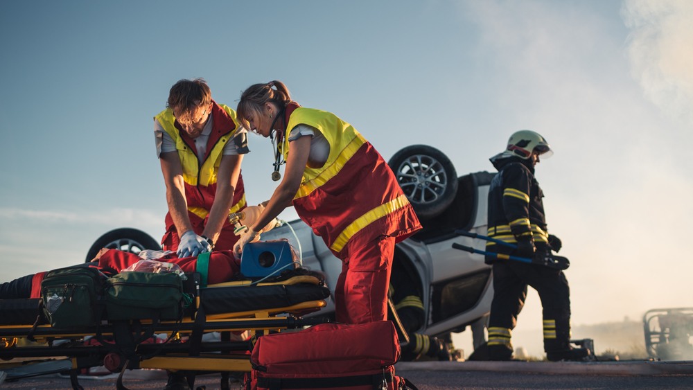 Paramedics and firefighters responding to a fatal car accident with an overturned vehicle in Georgia