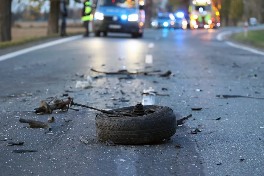 Crash debris on Georgia roadway with emergency vehicles responding